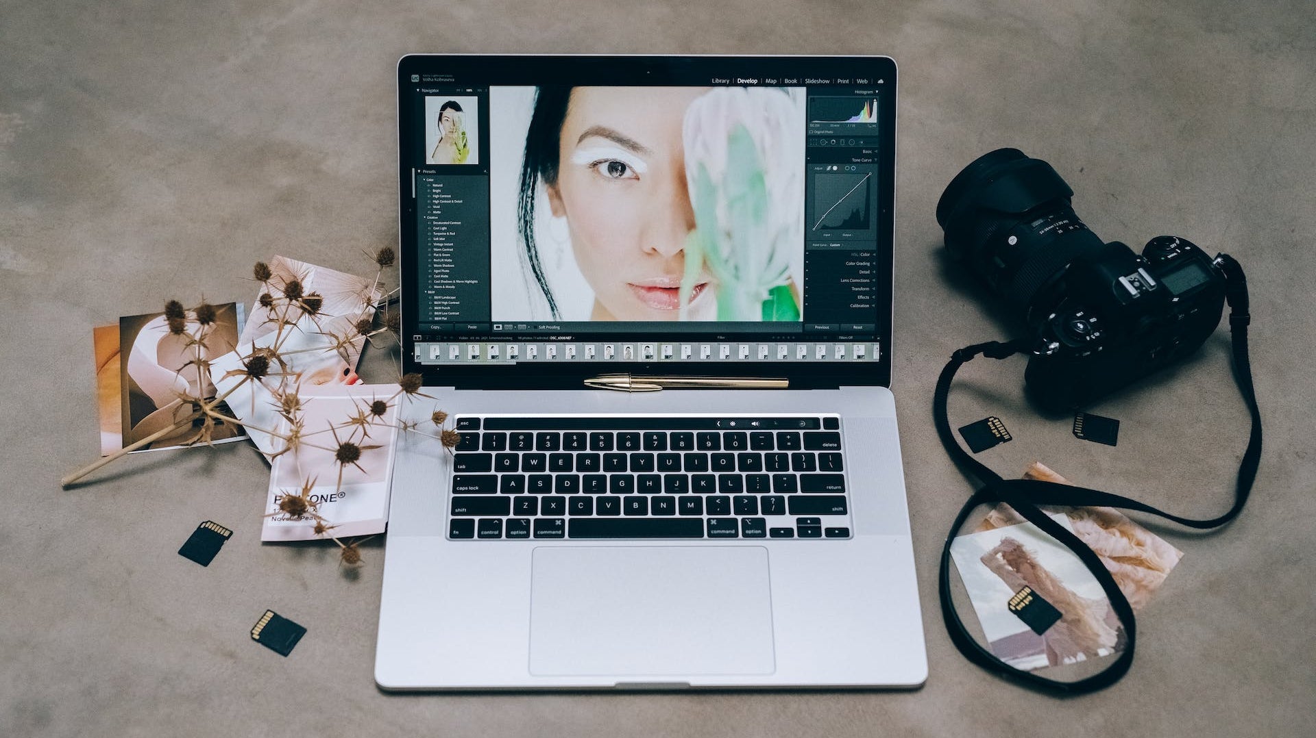 A Laptop and Dslr Camera on a Concrete Table by Leeloo The First